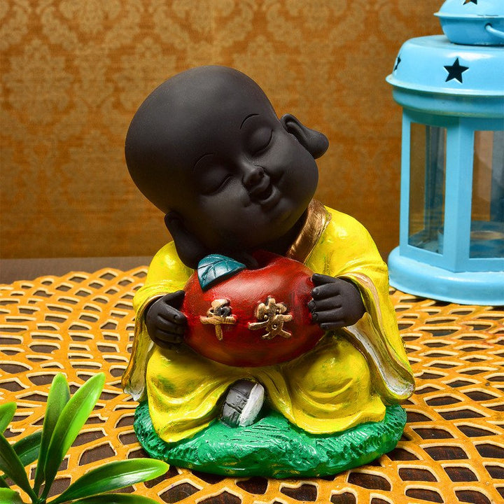 Handcrafted Ployresin Sitting With Taking Apple In Hand Lord Buddha Statue Showpiece Home Decor/Office Decor/Spiritual Gift, Yellow Colour - Karigaari India Aesthetic Home Decor